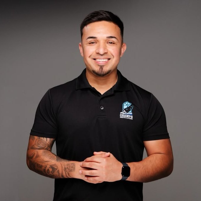 Vicente Vasquez, founder of Champs Window Cleaning, wearing a company polo shirt