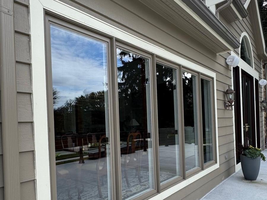 A wide five-panel picture window on a home exterior, cleaned inside and out