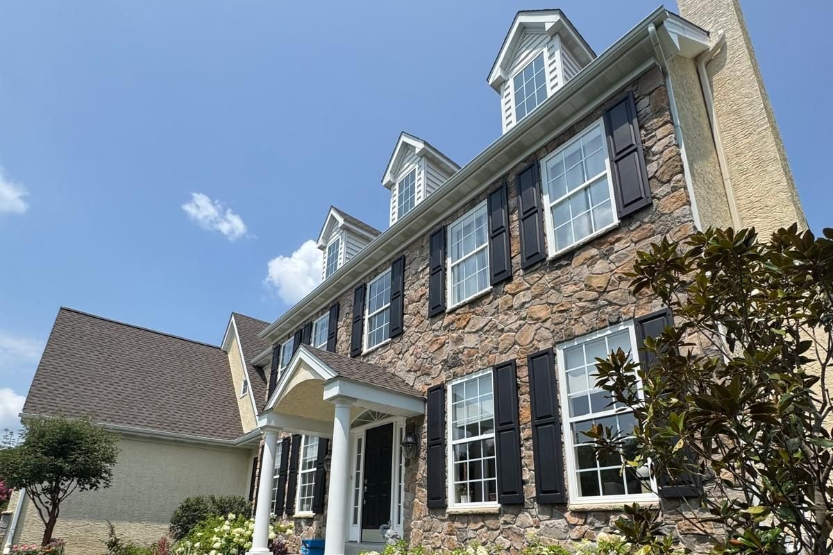 A brick colonial home with freshly cleaned windows